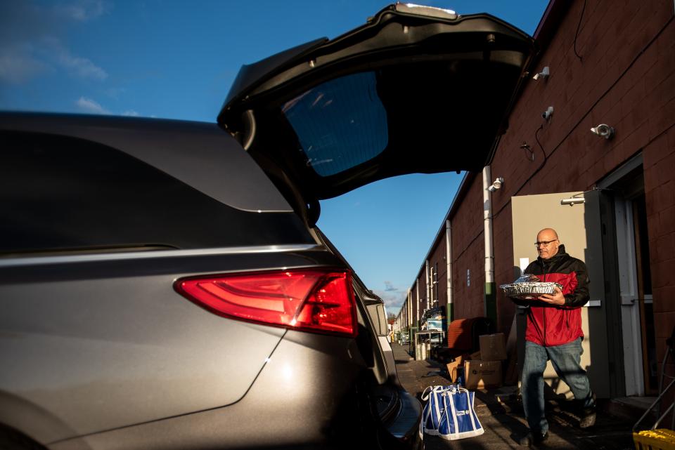 Thanksgiving meals are prepared and packaged at Douglass Pizzeria in Franklin Park through a program with Cornerstone Counseling Marriage & Family Intervention, a Princeton-based nonprofit, to support refugee families in need. Hamdy Mansour, owner of Douglas Pizzeria, loads dinners into his car for delivery on Tuesday November 23, 2021.