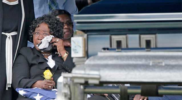 Judy Scott, mother of Walter Scott, wipes her eyes as she looks at her son's casket during his burial service in Charleston. Photo: AP