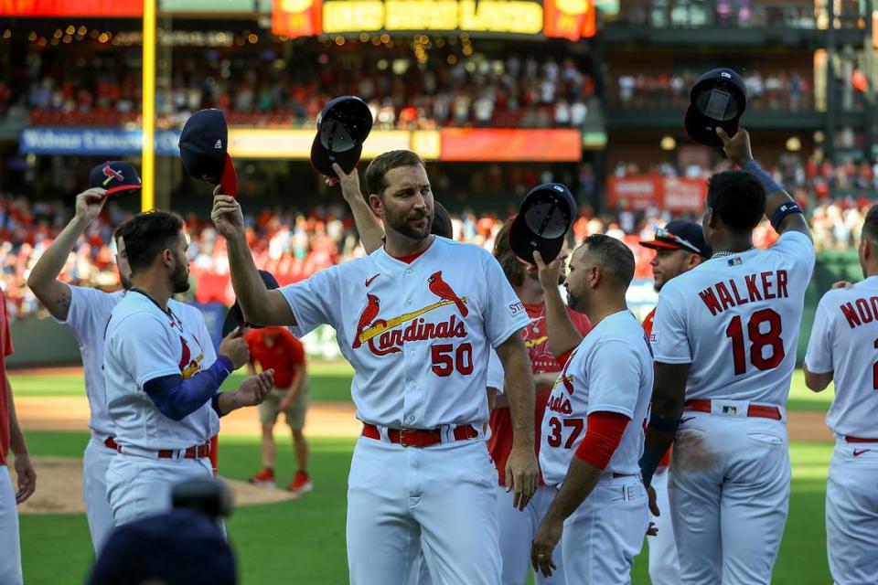 St. Louis Cardinals’ Adam Wainwright (50) and teammates raise their caps to fans after a baseball game against the Cincinnati Reds, Sunday, Oct. 1, 2023, in St. Louis. (AP Photo/Scott Kane)