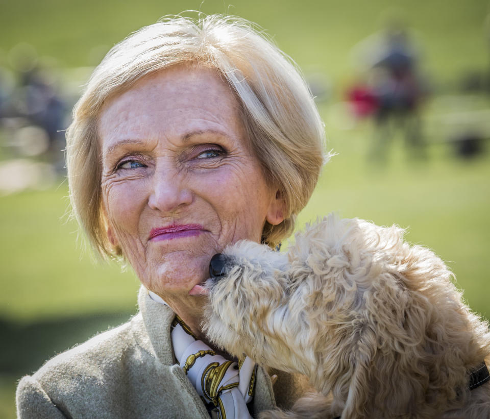 Country Fair President Mary Berry is licked by a dog called Henry during the Chatsworth Country Fair in Bakewell, Derbyshire. (Photo by Danny Lawson/PA Images via Getty Images)