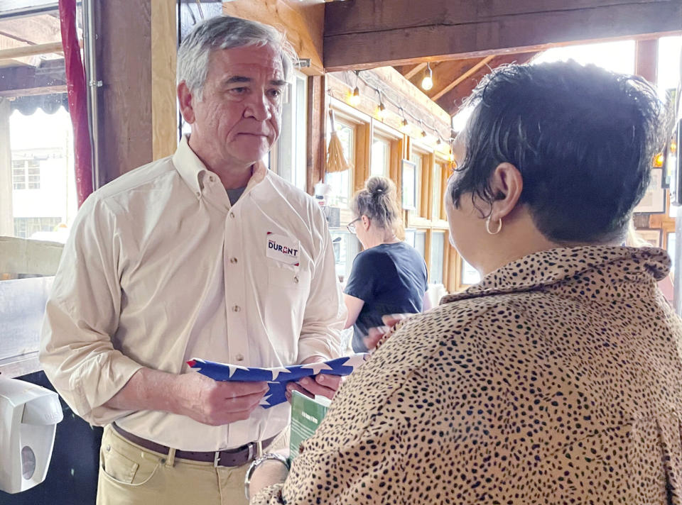 U.S. Senate candidate Mike Durant receives a folded U.S. flag from a supporter during a campaign stop in Homewood, Ala., on Monday, May 23, 2022. (AP Photo/Kim Chandler)