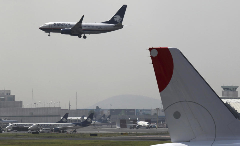 FILE - In this July 8, 2015 file photo, a plane prepares to land at the Benito Juarez International Airport in Mexico City. A $15.7-billion project for a new airport, which is about one-third completed and located next to Lake Nabor Carrillo, is threatening a decades-old effort to restore the lakes that originally covered the valley in which the capital is located. (AP Photo/Marco Ugarte, File)