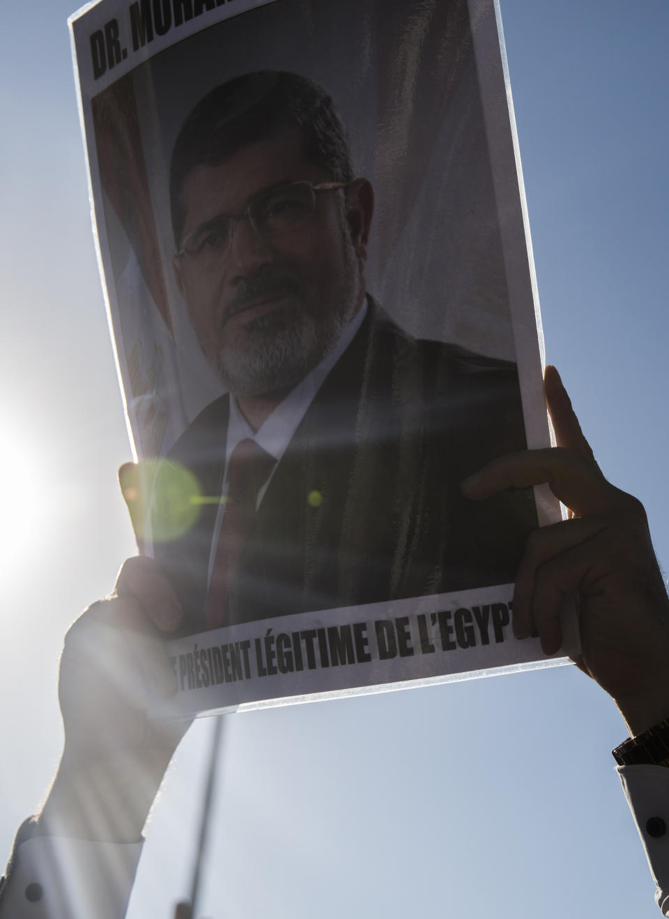 A man holds a picture of ousted former Egyptian President Mohammed Morsi in Tunis, Tunisia. Tuesday, June 18, 2019. The former president, who was ousted by current President Abdel-Fattah el-Sissi in a military coup in 2013, collapsed in a courtroom in Egypt during trial on Monday and died. (AP Photo/Hassene Dridi)