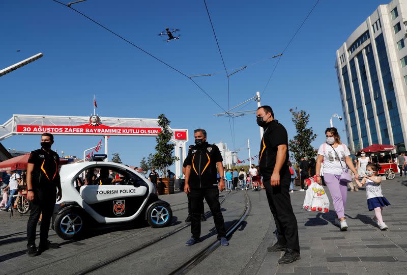 Members of Tourism Police patrol against people not wearing protective face masks in Istanbul