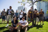 Fans look on at a makeshift memorial to former San Diego Padres outfielder Tony Gwynn at Petco Park in San Diego, California June 16, 2014. Gwynn, one of the greatest hitters of his generation, died on Monday at age 54 after a battle with cancer, the National Baseball Hall of Fame and Museum said. REUTERS/Sam Hodgson (UNITED STATES - Tags: SPORT BASEBALL OBITUARY)