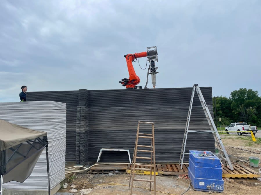 A robotic 3D printing arm is laying the walls of a fire-resistant ADU in Walnut, California. (RIC Technology)