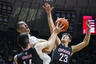 Purdue's Zach Edey (15) is fouled by Omaha's Dylan Brougham (14) and Frankie Fidler (23) as he shoots during the second half of an NCAA college basketball game in West Lafayette, Ind., Friday, Nov. 26, 2021. Purdue defeated Omaha 97-40. (AP Photo/Michael Conroy)