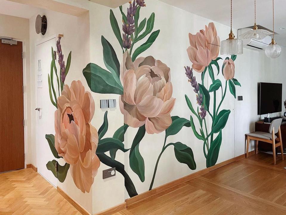 The completed mural painting of peonies and lavender wraps around a wall.