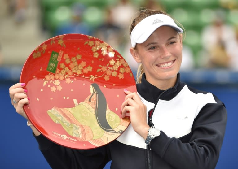 Denmark's Caroline Wozniacki holds the championship trophy at the Pan Pacific Open in Tokyo on September 24, 2017 after her victory against Anastasia Pavlyuchenkova of Russia