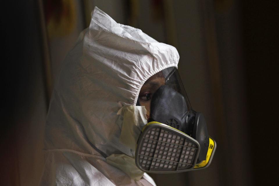 A paramedic from the fire department looks on after showing the media how to put on a protective suit, in Panama City October 2, 2014. The Ministry of Health in Panama is providing more protective suits for hospitals and airports, as measures against a possible Ebola outbreak, local media said. REUTERS/Carlos Jasso (PANAMA - Tags: HEALTH MEDIA SOCIETY)