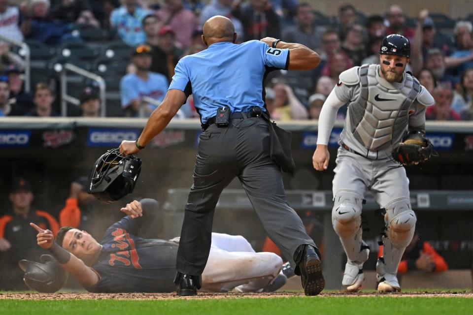 Home plate umpire CB Bucknor punches out Twins third base Gio Urshela after he is tagged by Tigers catcher Tucker Barnhart during the fourth inning on Tuesday, May 24, 2022, in Minneapolis.