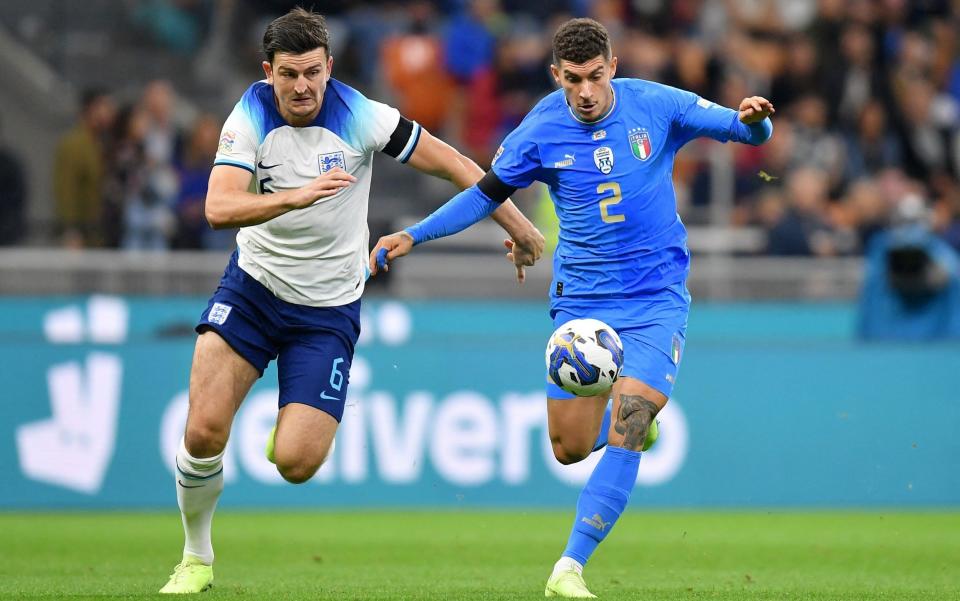 Harry Maguire in action with Italy's Giovanni Di Lorenzo  - REUTERS/Daniele Mascolo