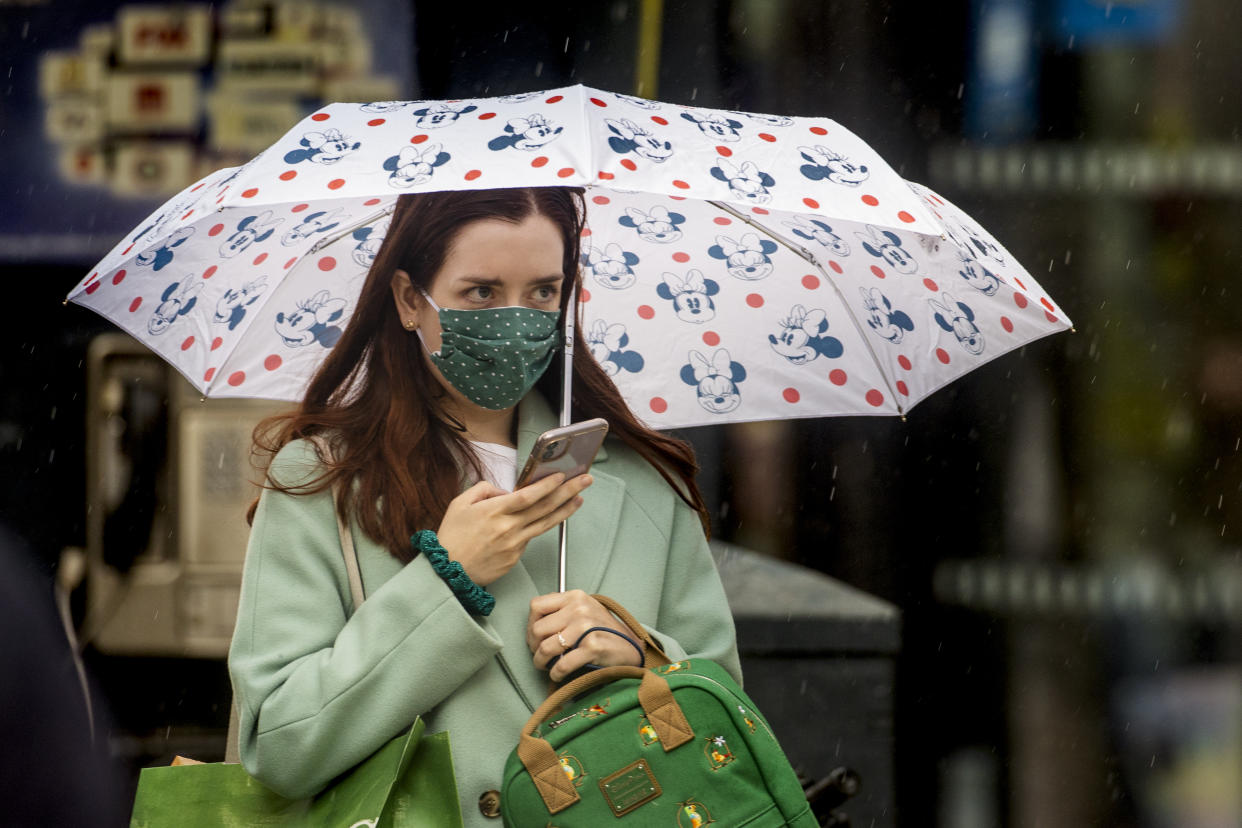 A woman walks through Belfast City CentreÕs shopping district wearing a face mask on the day it was announced face masks will become mandatory in shops in England. (Photo by Liam McBurney/PA Images via Getty Images)
