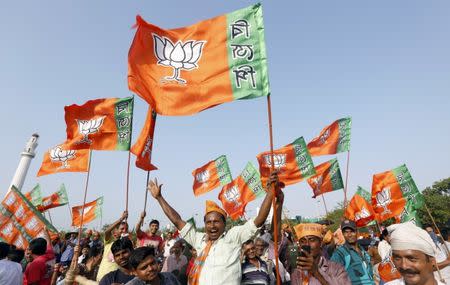 Supporters of India's ruling Bharatiya Janata Party (BJP) wave their party's flags as they wait for Prime Minister Narendra Modi to address an election campaign rally in Kolkata, April 17, 2016. REUTERS/Rupak De Chowdhuri/Files