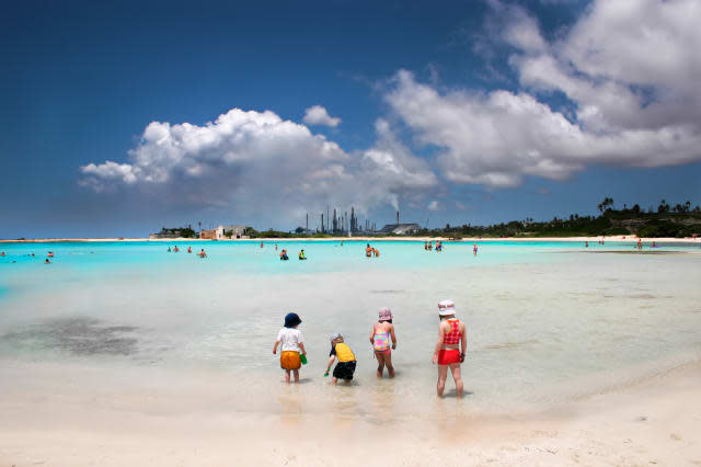 baby beach in aruba, a surreal mix of industry and holiday fun.