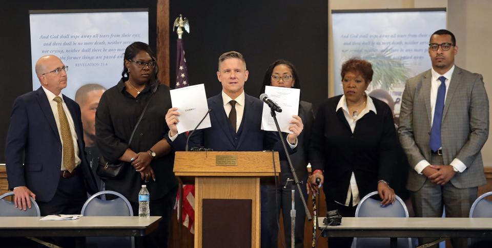 Bobby DiCello, one of the attorneys representing the family of Jayland Walker, holds up documents related to their $45 million lawsuit filed against the city of Akron, mayor, the eight officers who shot and killed Jayland last summer and others during a press conference at the First Congregational Church of Akron, Friday, June 16, 2023, in Akron, Ohio.