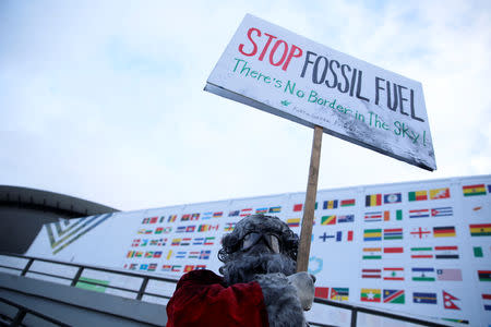 Environmental activist protests against fossil fuel in front of the the venue of the COP24 UN Climate Change Conference 2018 in Katowice, Poland December 10, 2018