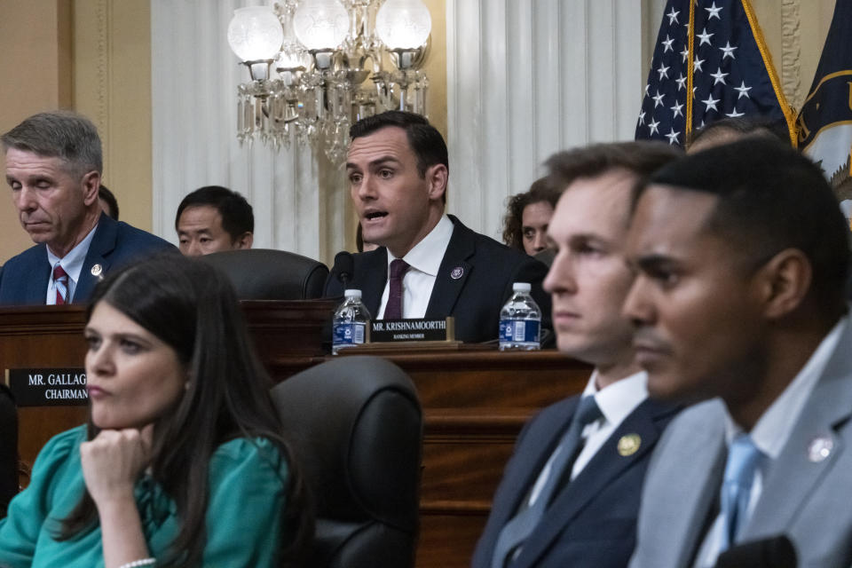 Mike Gallagher delivers remarks while sitting on a panel with other officials.