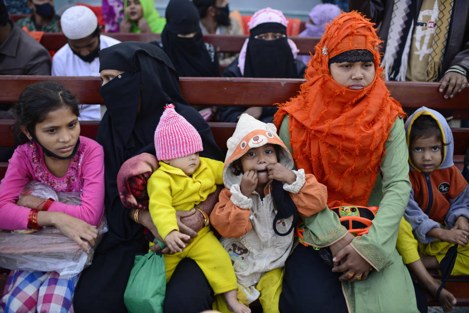 Rohingya refugees wait in a naval ship to be transported to an isolated island in the Bay of Bengal, in Chittagong, Bangladesh, Tuesday, Dec. 29, 2020. Officials in Bangladesh sent a second group of Rohingya refugees to the island on Monday despite calls by human rights groups for a halt to the process. The Prime Minister’s Office said in a statement that more than 1,500 Rohingya refugees left Cox’s Bazar voluntarily under government management. Authorities say the refugees were selected for relocation based on their willingness, and that no pressure was applied on them. But several human rights and activist groups say some refugees have been forced to go to the island, located 21 miles (34 kilometers) from the mainland. (AP Photo/Mahmud Hossain Opu)