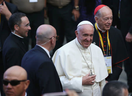 Pope Francis (C) smiles while walking with Lima's Archbishop Juan Luis Cipriani (R) outside the nunciature, in Lima, Peru January 18, 2018. REUTERS/Guadalupe Pardo