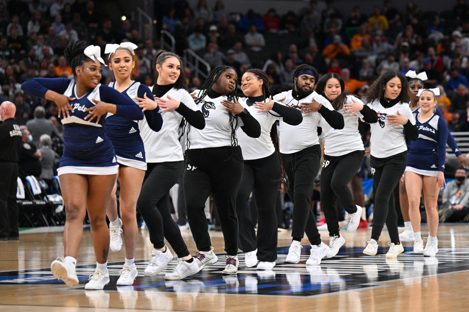 INDIANAPOLIS, IN - MARCH 19: St. Peter's Peacocks dancers perform on the court during a break in the second half of action against the Murray State Racers in the second round of the 2022 NCAA Men's Basketball Tournament held at Gainbridge Fieldhouse on March 19, 2022 in Indianapolis, Indiana. Michigan won 76-68. (Photo by Jamie Sabau/NCAA Photos via Getty Images)