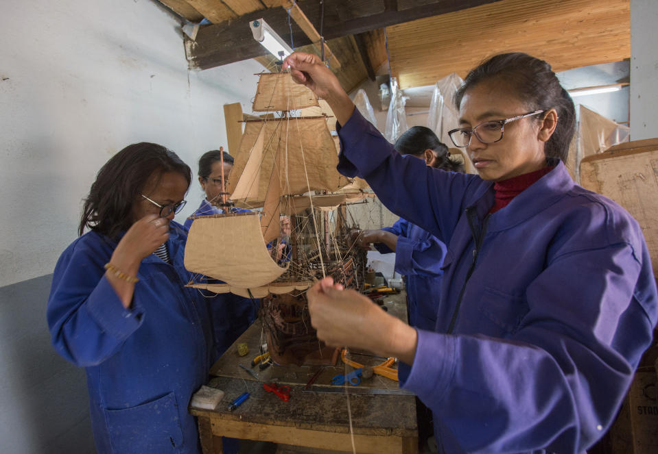 Malagasy women build a model ship at the Le Village model ship making company in Antananarivo, Madagascar, Wednesday, Sept. 11, 2024. (AP Photo/Alexander Joe)