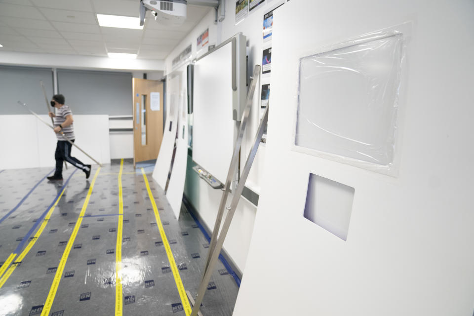 A Covid testing area is constructed at Great Academy Ashton,, as the school prepares for its reopening on March 8 after the latest lockdown curb the spread of coronavirus, in Ashton-Under-Lyne, England, Thursday, March 4, 2021. The school with approximately 1300 pupils aged 11 to 16 in Greater Manchester will have to conduct around 450 tests per day on pupils and staff in the first 2 weeks after the return of students on Monday. (AP Photo Jon Super)