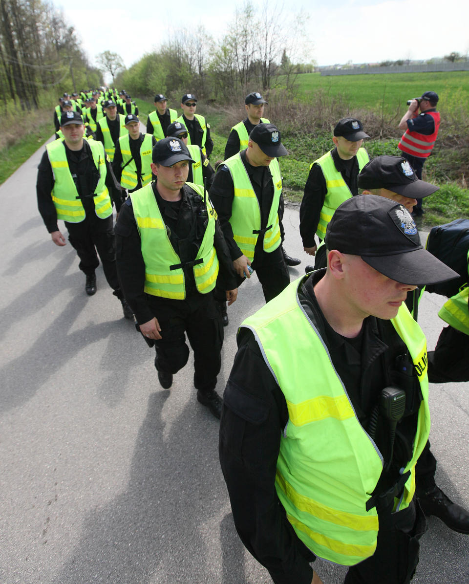 In a major security exercise, policemen are arriving to take part in the search of woods for foreigners who fled after their helicopter crash landed near Jasce, Poland on Wednesday, April 23, 2014. The three-day exercise is to test the response of internal security services including police, firefighters and border guards to emergency situations and is held at a time of conflict between Poland’s two neighbors, Ukraine and Russia. (AP Photo/Czarek Sokolowski)