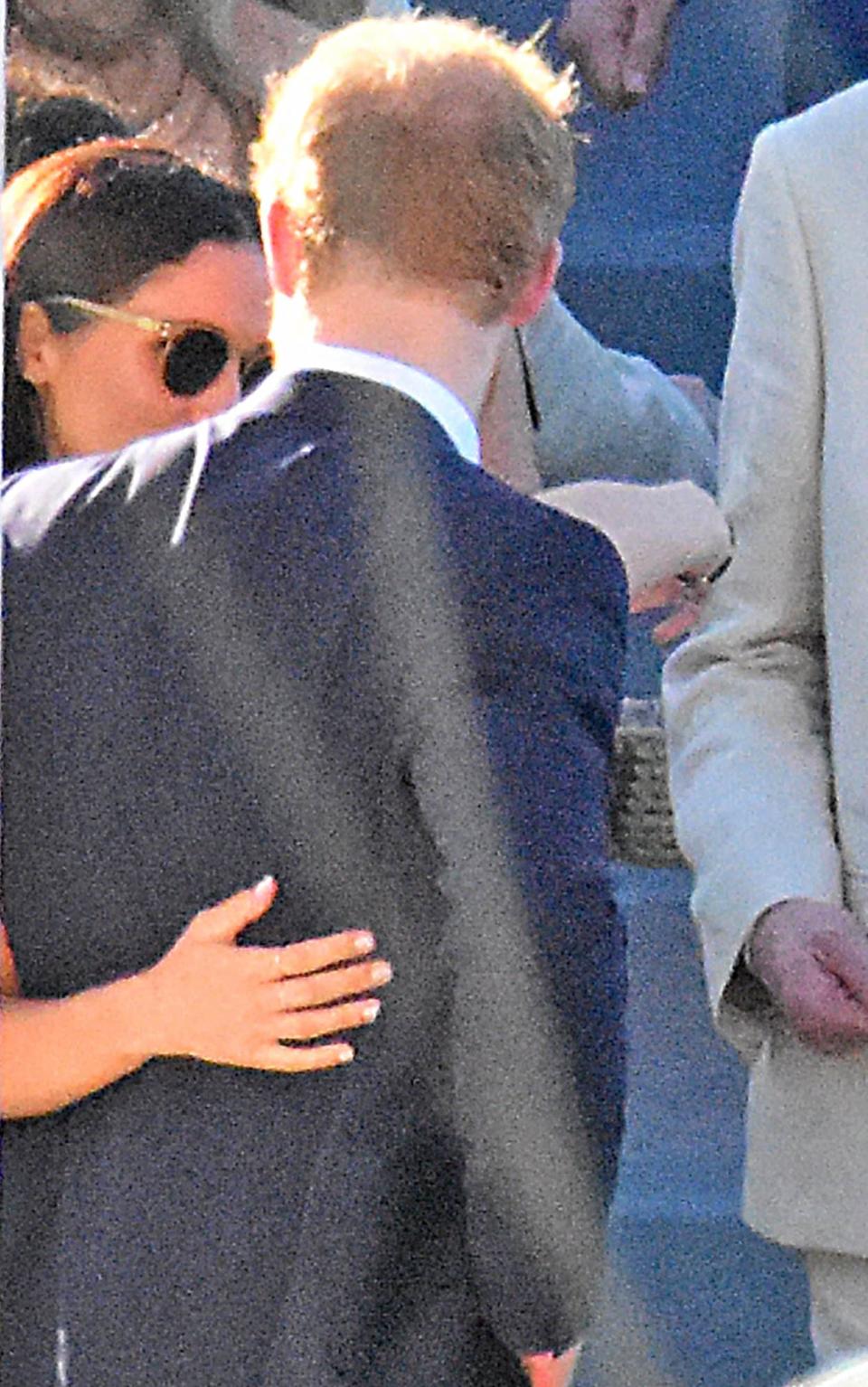 Prince Harry and Meghan Markle put on an affectionate display as they attend wedding in Jamaica