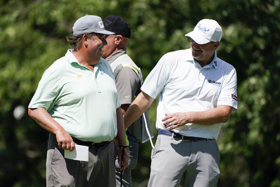 Tim Herron laughs with Tom Gillis, right, after making a birdie putt on the 18th green during the second round of the PGA Tour Champions Principal Charity Classic golf tournament, Saturday, June 5, 2021, in Des Moines, Iowa. (AP Photo/Charlie Neibergall)