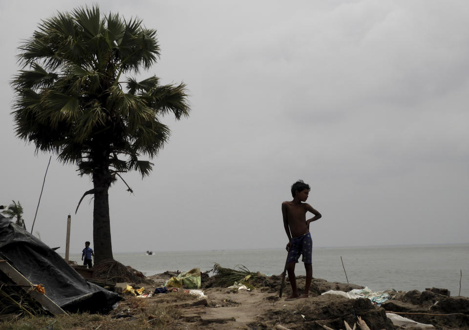 This May 22, 2020 photo shows a boy looking at the damage caused by Cyclone Amphan in Deulbari village, in South 24 Parganas district in the Sundarbans, West Bengal state, India. The cyclone that struck India and Bangladesh last month passed through the Sundarbans, devastating the islands that are home to one of the world’s largest mangrove forests and is a UNESCO world heritage site. (Samrat Paul via AP)