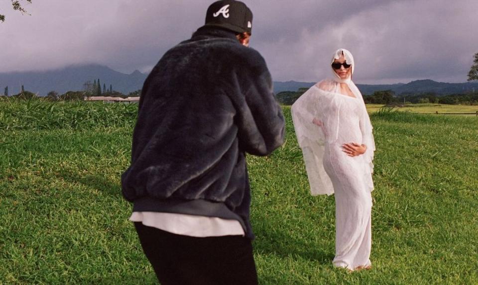 a man and woman standing in a field