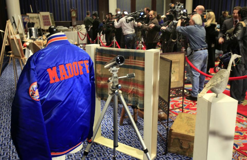 FILE - A New York Mets baseball jacket, personalized for Bernard Madoff, is displayed during an auction preview of his seized items, in New York, Friday, Nov. 13, 2009. Epic Ponzi scheme mastermind Bernard Madoff is dead. But the effort to untangle his web of deceit lives on. More than 12 years after Madoff confessed to running the biggest financial fraud in Wall Street history, a team of lawyers is still at work on a sprawling effort to recover money for the thousands of victims of his scam.(AP Photo/Richard Drew, File)