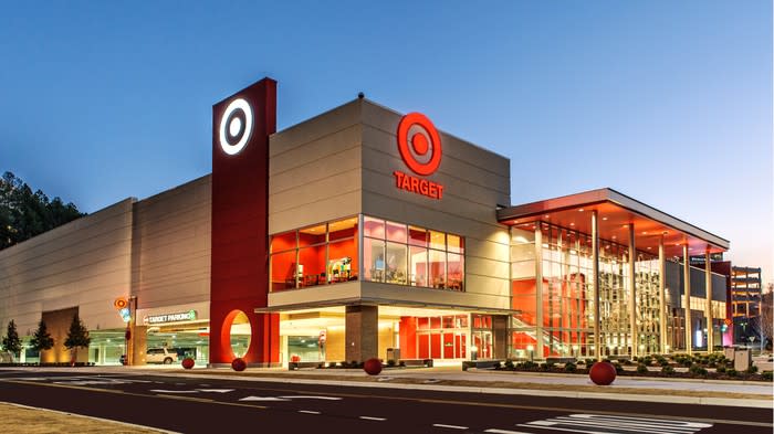 Exterior shot of a Target store illuminated against a darkening sky.