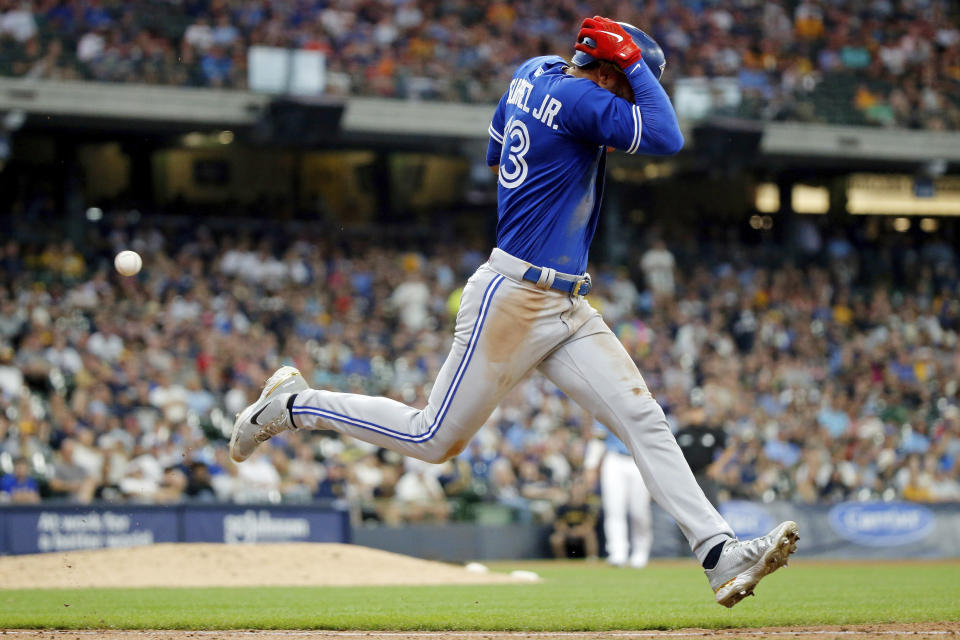 Toronto Blue Jays' Lourdes Gurriel Jr. runs to first base before being forced out on a dropped third strike for the final out of the seventh inning of a baseball game against the Milwaukee Brewers, Saturday, June 25, 2022, in Milwaukee. (AP Photo/Jon Durr)