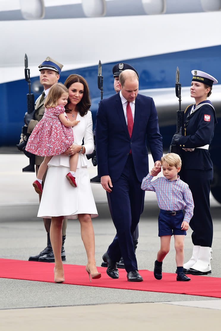 The royals disembarked the plane with the Duchess of Cambridge, dressed in Alexander McQueen, carrying Princess Charlotte, in a ditsy floral dress, while Prince William held 3-year-old Prince George’s hand. [Photo: PA]