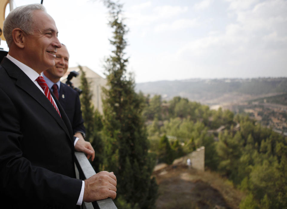 Israeli Prime Minister Benjamin Netanyahu looks at the area where Israel plans to build some 800 new housing units during his visit to the east Jerusalem Jewish neighborhood of Gilo, Tuesday, Oct. 23, 2012. Netanyahu vowed on Tuesday to continue building in a Jerusalem district days after European Union criticism because it is claimed by Palestinians.(AP Photo/Gali Tibbon, Pool)