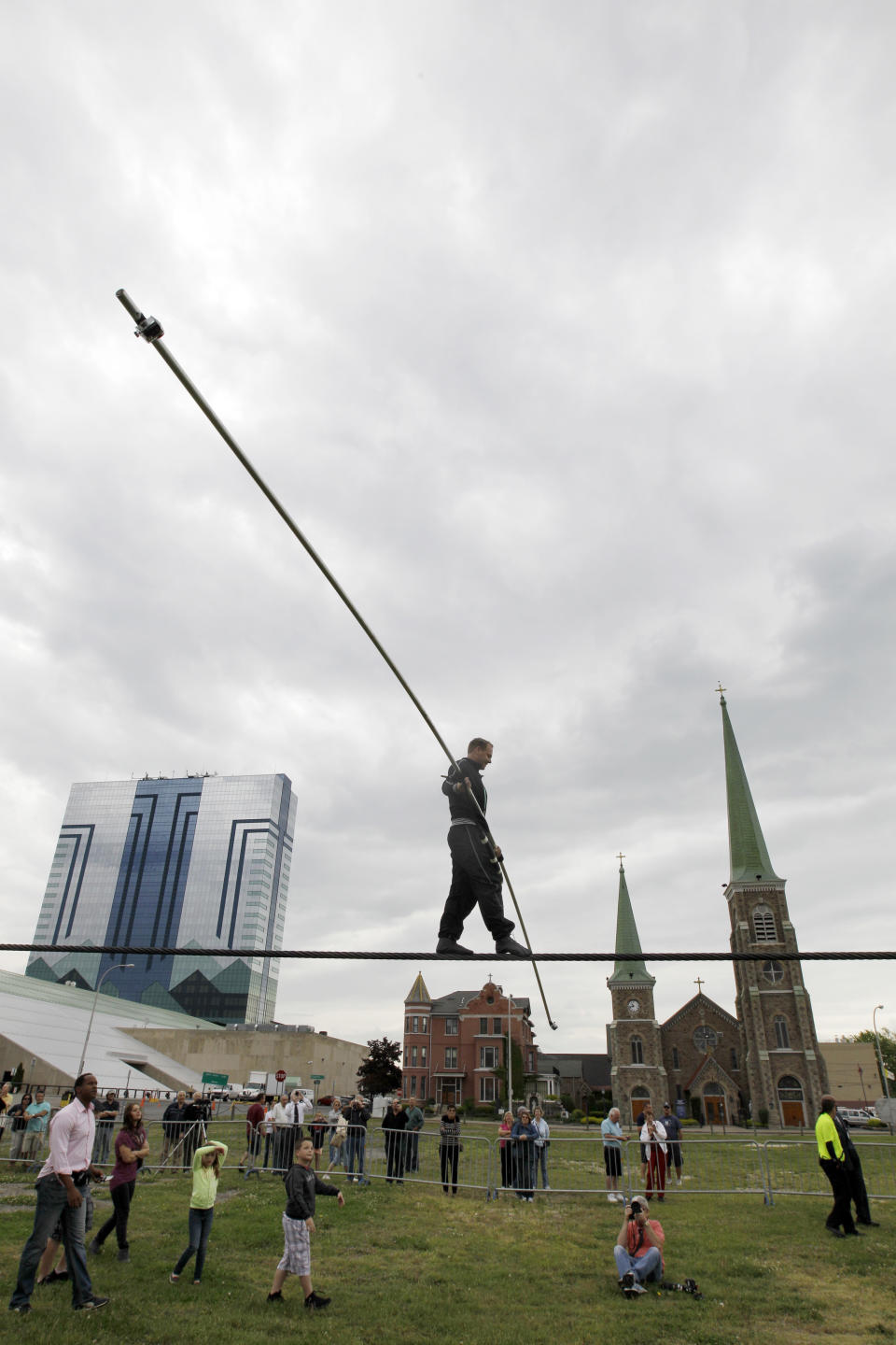 FILE - This May 16, 2012 file photo shows Nik Wallenda performing a walk on a tightrope in the rain during training at the Seneca Niagara Casino for his walk over Niagara Falls in Niagara Falls, N.Y. In recent years, for economic reasons, Niagara Falls has thrown open its doors to casino gambling, gay weddings and a tightrope walk that, until laws were relaxed, would have meant arrest. It even briefly considered taking in toxic wastewater from hydraulic fracturing. On the drawing board now is a plan to entice young people to move in by paying down their student loans. (AP Photo/David Duprey, File)