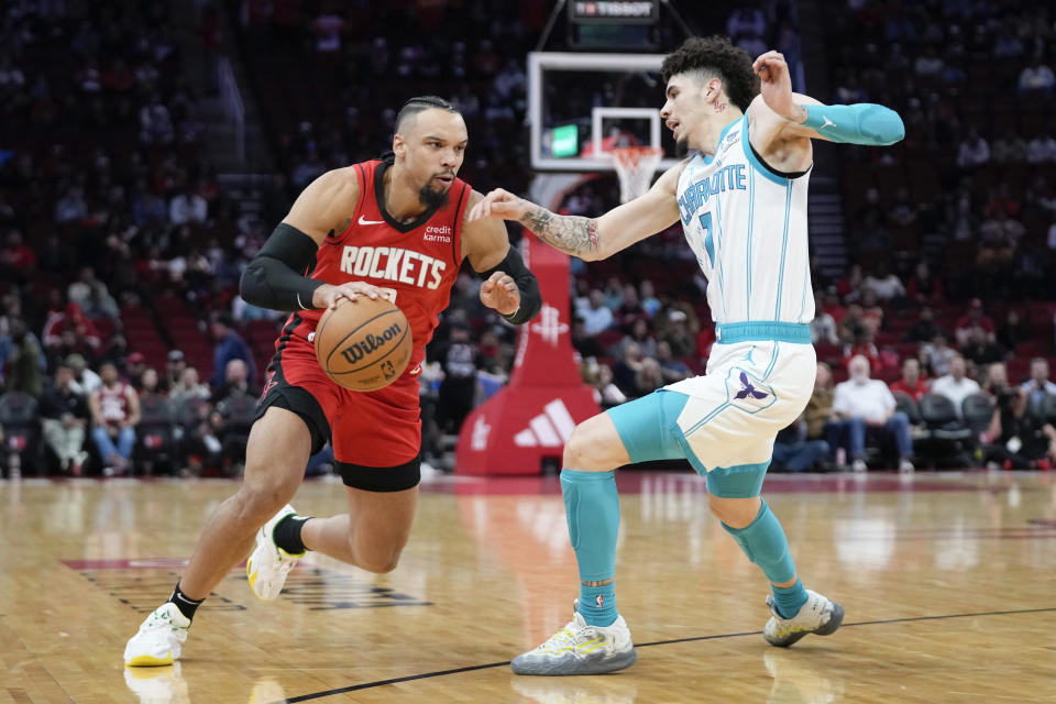 Houston Rockets forward Dillon Brooks, left, dribbles the ball as Charlotte Hornets guard LaMelo Ball defends during the first half of an NBA basketball game Wednesday, Nov. 1, 2023, in Houston. (AP Photo/Eric Christian Smith)