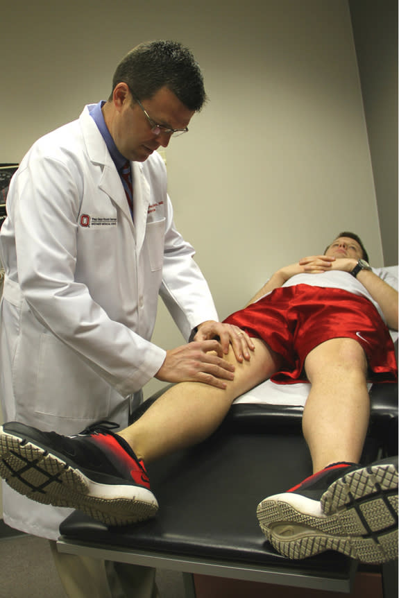 Dr. James Borchers examines the knee of a spring sport athlete at Ohio State's Wexner Medical Center. Borchers says athletes who play one sport that spans extremes in weather face unique injury risks. Sports like lacrosse often begin in frigid