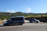 Catalan Mossos d'Escuadra officers and vans block a road near the place where a suspect was killed by police in Sant Sadurni d'Noia, Spain August 21, 2017. REUTERS/Albert Gea