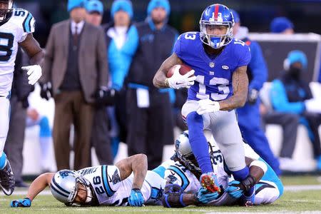 Dec 20, 2015; East Rutherford, NJ, USA; New York Giants wide receiver Odell Beckham Jr. (13) runs the ball past Carolina Panthers cornerback Cortland Finnegan (26) and defensive back Charles Tillman (31) during the fourth quarter at MetLife Stadium. Mandatory Credit: Brad Penner-USA TODAY Sports