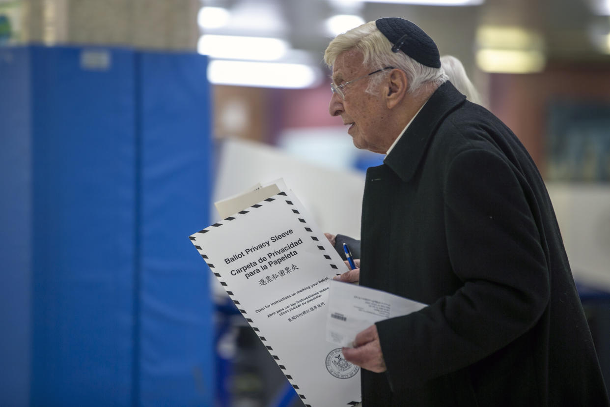 A voter at Frank McCourt High School, an early voting polling site, in Manhattan, Nov. 1. (Ted Shaffrey/AP)