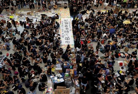 Anti-extradition bill demonstrators attend a protest at the arrival hall of Hong Kong Airport