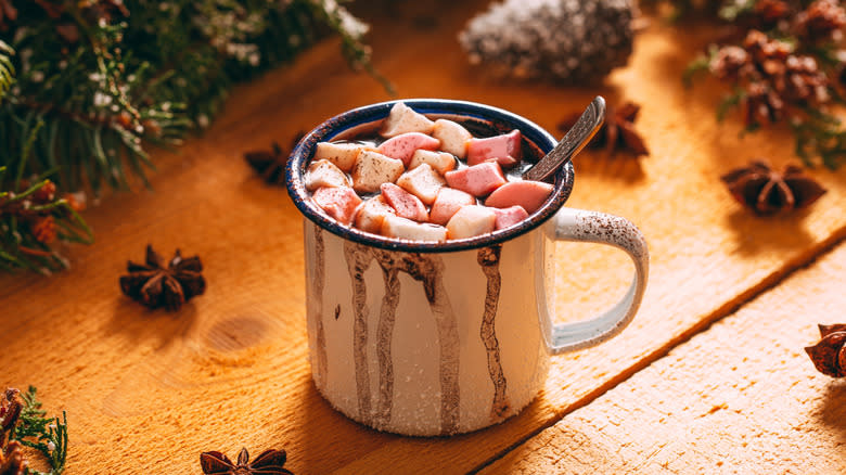 dripping mug of hot cocoa with marshmallows