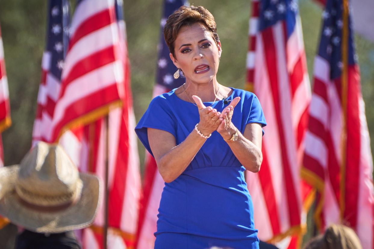 Gubernatorial candidate Kari Lake leaves the stage after delivering remarks during former President Donald Trump's rally at Legacy Sports Park in Mesa on Sunday, Oct. 9, 2022.