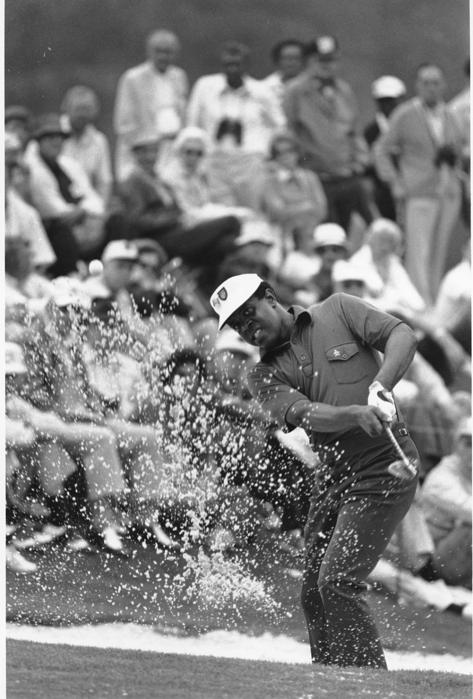 Lee Elder hits out of a sand trap on the 18th hole at Augusta National on April 10, 1975.