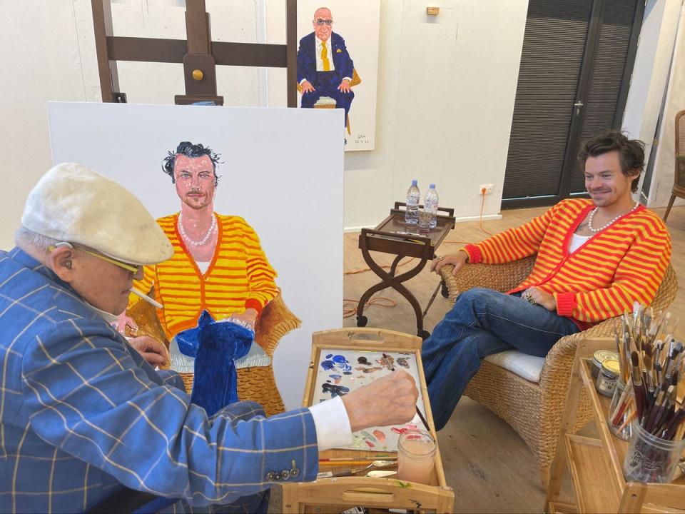 David Hockney paints Harry Styles in his Molly Goddard cardigan (PA)