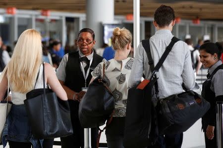 REFILE: UPDATING SLUG TO NEW YORK-AIRPORT/Airport private contractors prepare passengers at a security checkpoint during the check-in process at at JFK airport in the Queens borough of New York City, U.S., May 27, 2016. REUTERS/Brendan McDermid/File Photo