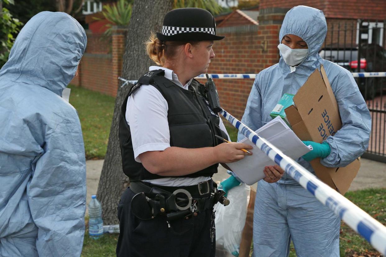 Murder investigation: Forensic officers at the scene in Kingston: Nigel Howard